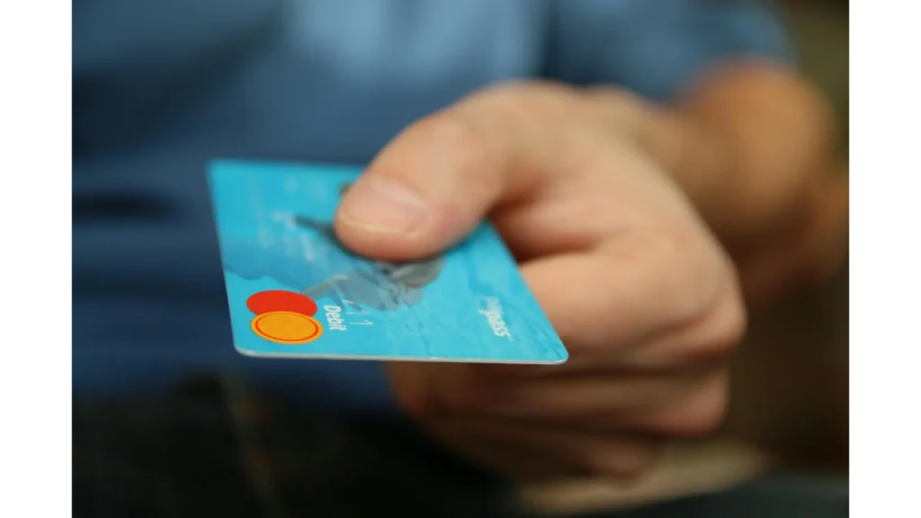 Close-up of a person holding a debit card, representing Emotist’s secure and transparent payment system for mental health professionals